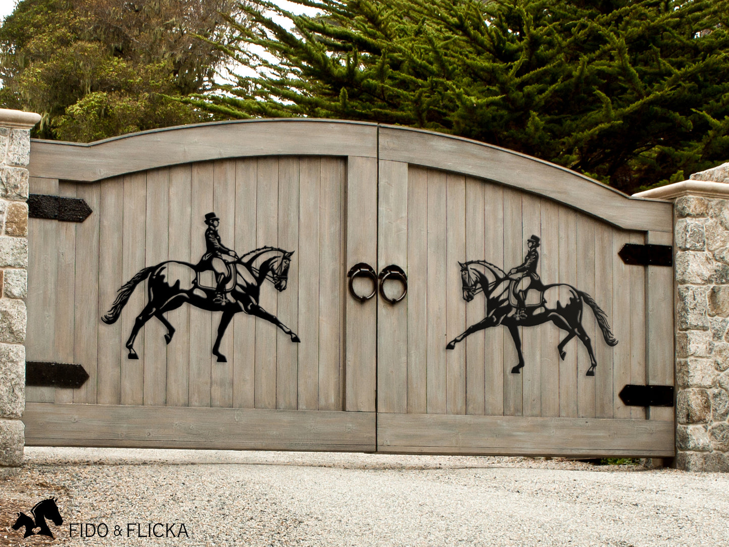 Metal dressage horses on wooden driveway gate