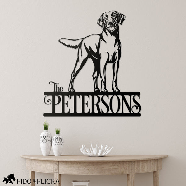 Labrador retriever personalized metal sign with family name hanging in entry of home