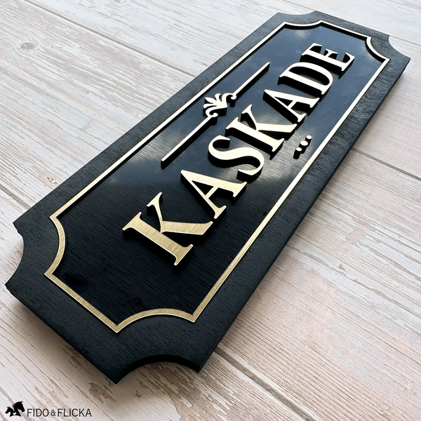 Personalized horse stall sign with brushed gold acrylic letters on black wood backing reading KASKADE by Fido and Flicka