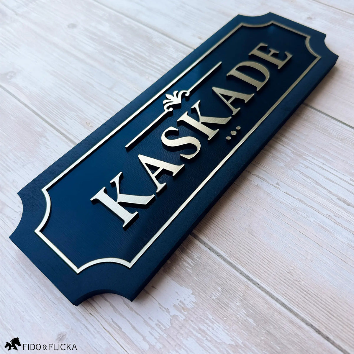 Personalized horse stall sign with brushed gold acrylic letters on black wood backing reading KASKADE by Fido and Flicka