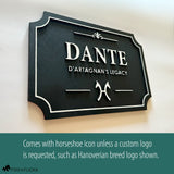Personalized horse stall sign in layered Baltic birch with white on black finish, shown with custom Hanoverian breed logo. Standard design includes horseshoe icon unless a custom logo is requested