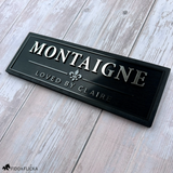 Black personalized horse stall sign with raised silver lettering, Graphite metallic accents, fleur-de-lis emblem, and custom secondary text.