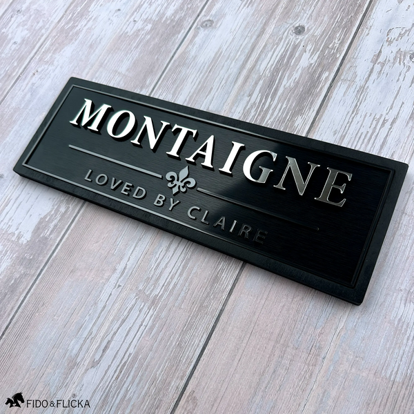 Black personalized horse stall sign with raised silver lettering, Graphite metallic accents, fleur-de-lis emblem, and custom secondary text.