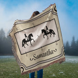 Person holding a blanket with dressage horse and rider silhouettes and the name 'Samantha' on a grassy field background.