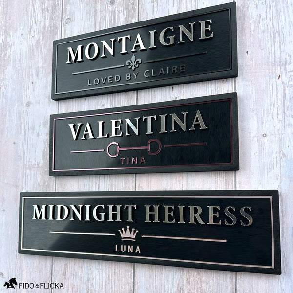 Three luxury personalized horse stall name plates shown in Graphite, Merlot, and Rosé Champagne metallic finishes with custom horse names and emblems.