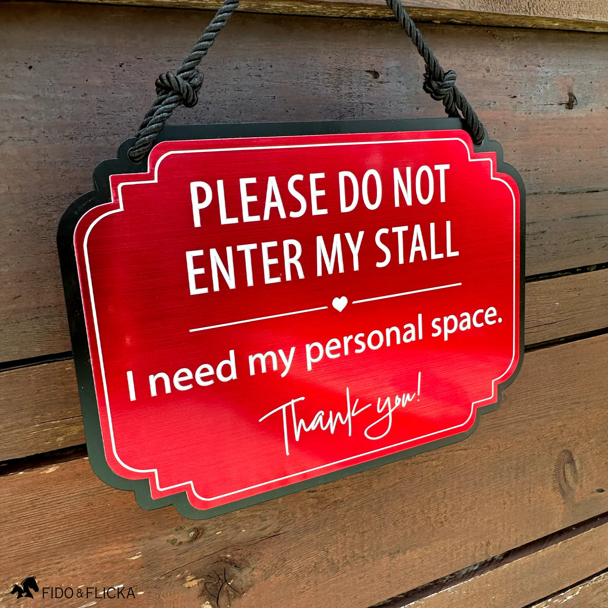 Red horse stall warning sign reading “Please Do Not Enter My Stall, I need my personal space” hanging on a rustic wood stall door
