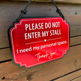 Red horse stall warning sign reading “Please Do Not Enter My Stall, I need my personal space” hanging on a rustic wood stall door