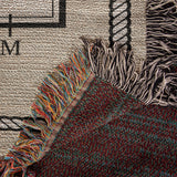 Close-up of woven cotton dressage arena blanket showing detailed rope border, arena lettering, and colorful fringe edges