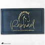 Elegant black wood horse stall nameplate featuring a gold silhouette of a braided show horse and the name “Raphael,” with the inscription “Loved by Georgianna.” Custom equestrian sign by Fido & Flicka, modern and personalized design.