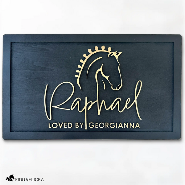 Elegant black wood horse stall nameplate featuring a gold silhouette of a braided show horse and the name “Raphael,” with the inscription “Loved by Georgianna.” Custom equestrian sign by Fido & Flicka, modern and personalized design.