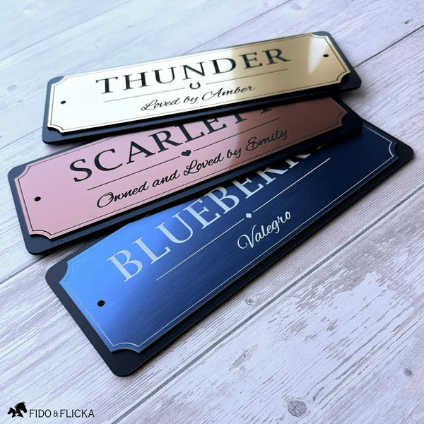 Three personalized horse stall signs in brushed gold, copper, and blue metallic finishes with black acrylic backing, showcasing custom engraved horse name plaques by Fido & Flicka.