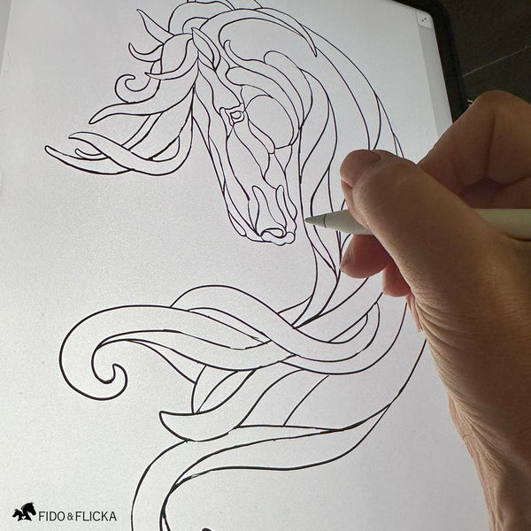 Artist sketching the original design for Noble Drift horse wall art on a digital tablet, capturing the flowing lines and abstract form.