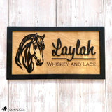 Personalized wooden horse stall sign made from Baltic birch. Features layered black horse head design and engraved text nickname of horse.
