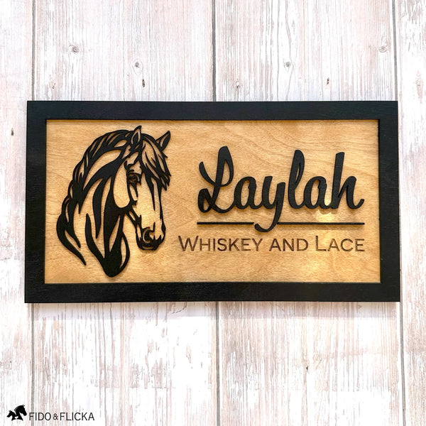 Personalized wooden horse stall sign made from Baltic birch. Features layered black horse head design and engraved text nickname of horse.
