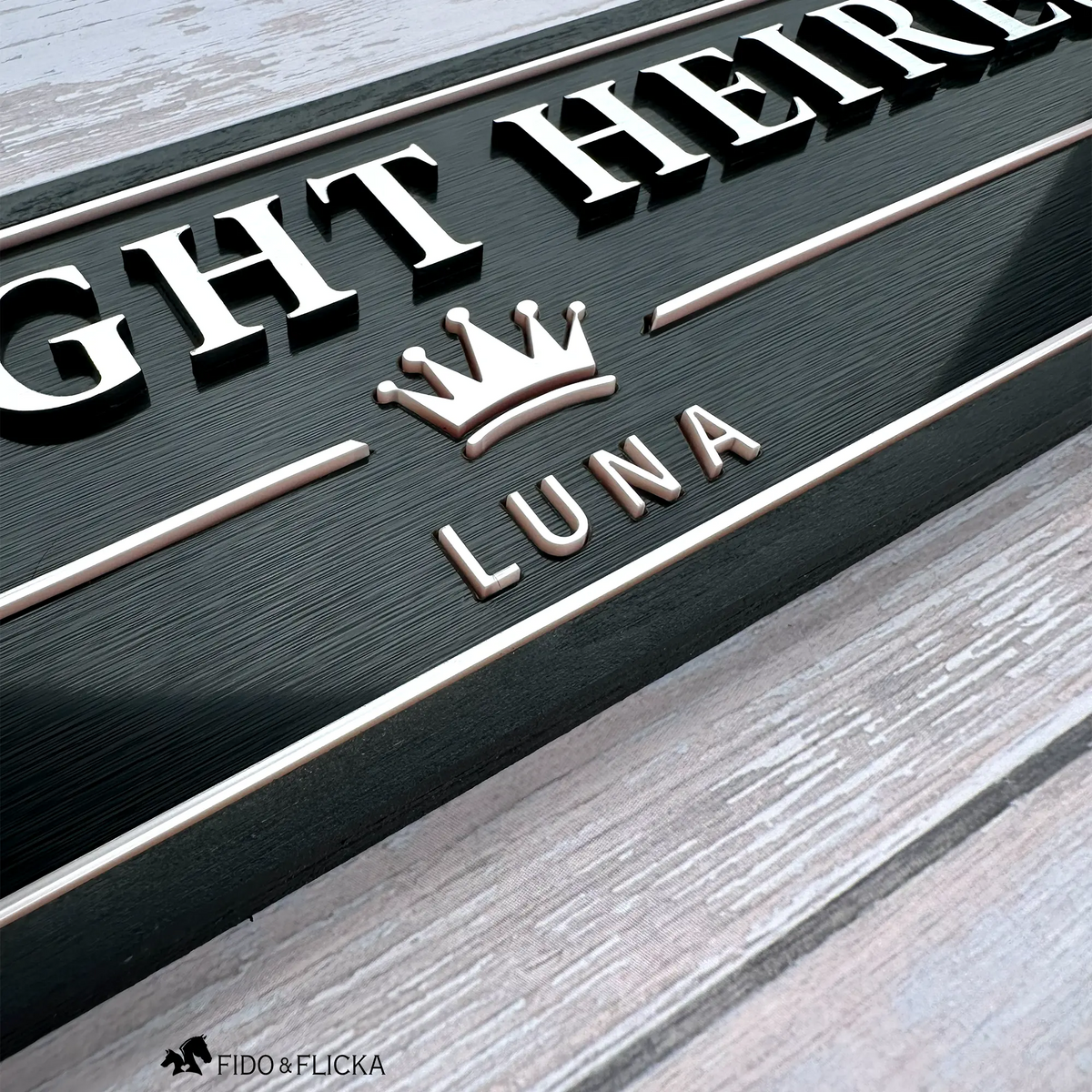 Close-up of a personalized horse stall sign showing raised metallic letters, Rosé Champagne crown emblem, inset border, and dimensional details.
