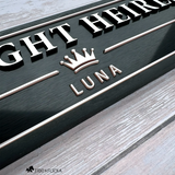 Close-up of a personalized horse stall sign showing raised metallic letters, Rosé Champagne crown emblem, inset border, and dimensional details.