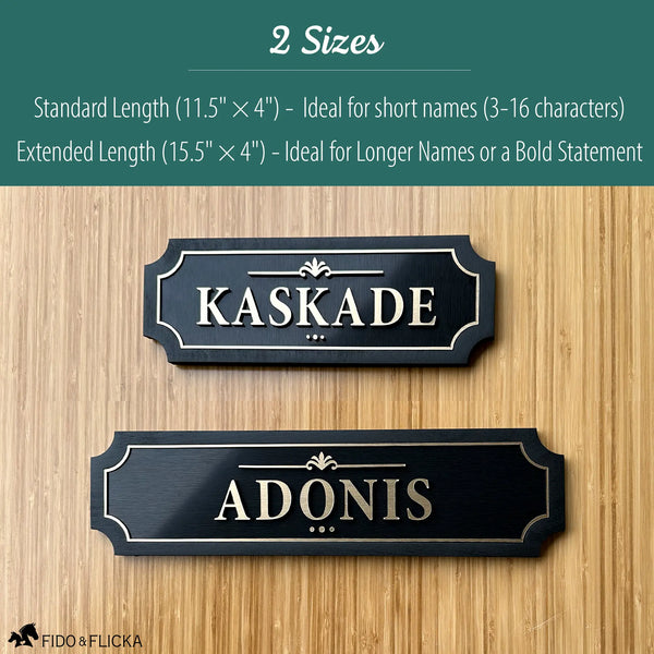 Comparison of two black and gold layered acrylic and wood horse stall name plates showing size options: an 11.5×4 inch sign reading ‘Kaskade’ above a 15.5×4 inch extended-length sign reading ‘Adonis,’ displayed on a light wood background