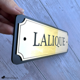 Close-up of a personalized horse stall sign showing the slim 3/16-inch profile, layered construction, and premium brushed gold metallic finish.