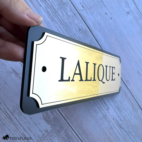 Close-up of a personalized horse stall sign showing the slim 3/16-inch profile, layered construction, and premium brushed gold metallic finish.
