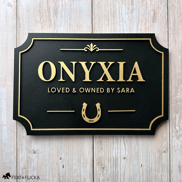 Custom horse stall sign made from layered Baltic birch wood, gold on black finish with personalized name and horseshoe design – durable equestrian barn name plaque.