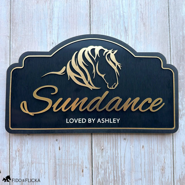 Personalized horse stall sign with brushed gold acrylic horse artwork, custom horse name, and engraved text on a black acrylic plaque.