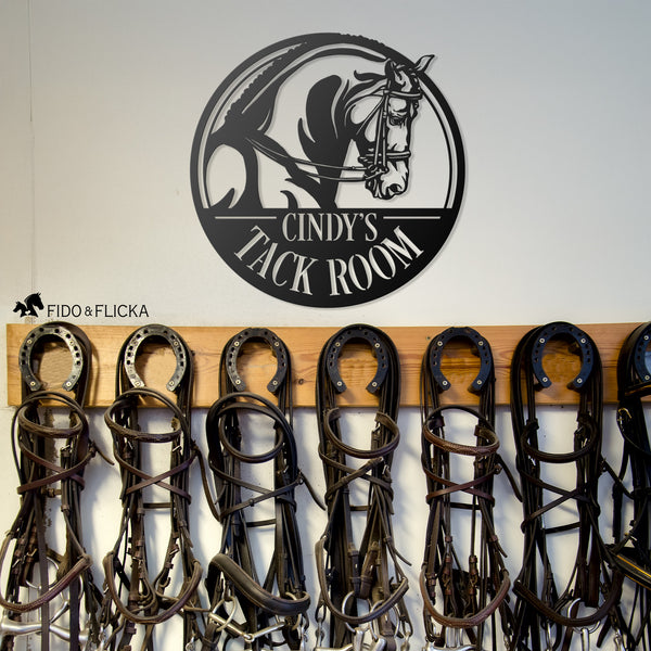 personalized metal tack room sign hanging in a horse barn tack room