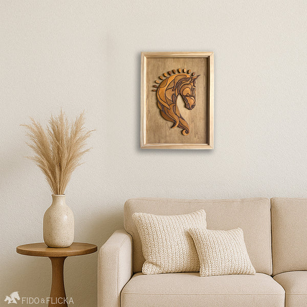 Framed wooden horse head wall art displayed on a light-colored wall above a neutral-toned couch with knitted pillows. The living space includes a round wooden side table with a ceramic vase filled with pampas grass, creating a cozy and elegant equestrian-inspired interior.