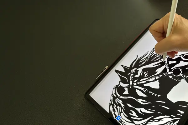  Person drawing a horse on a digital tablet with a stylus.