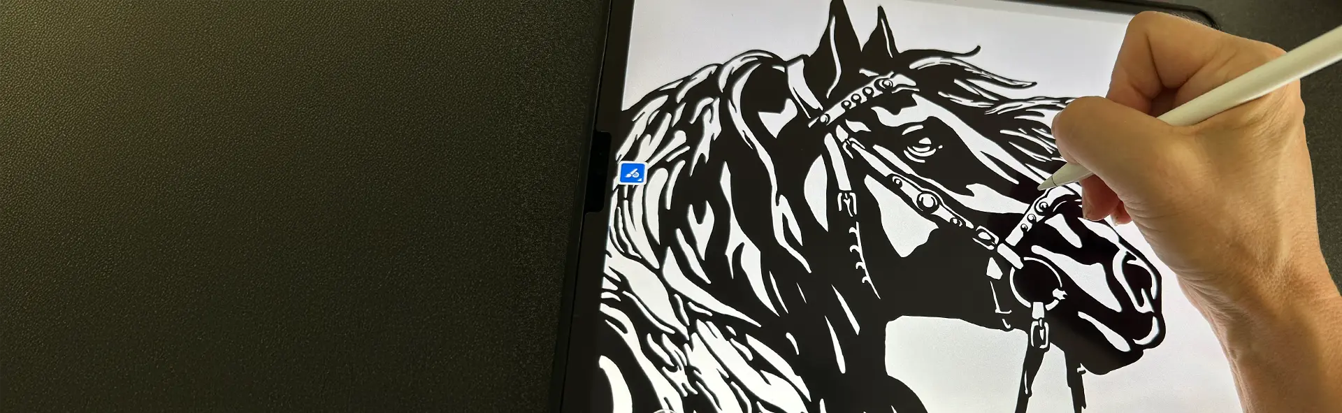  digital Hand drawing a black horse on an ipad with a pen.