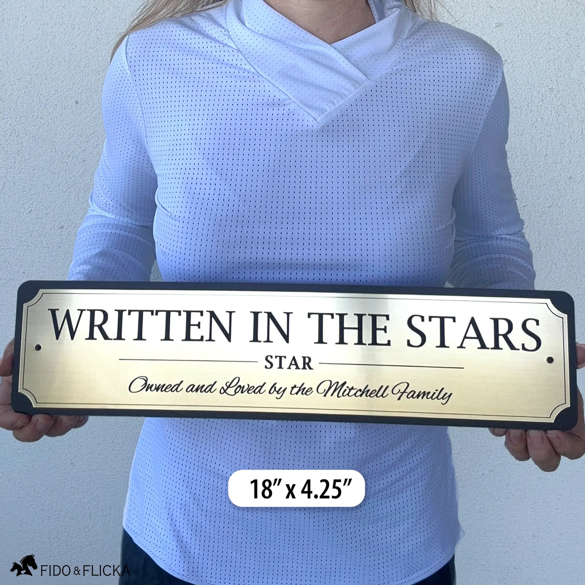 Person holding an 18-inch personalized horse stall sign to demonstrate the size of the premium engraved acrylic plaque.