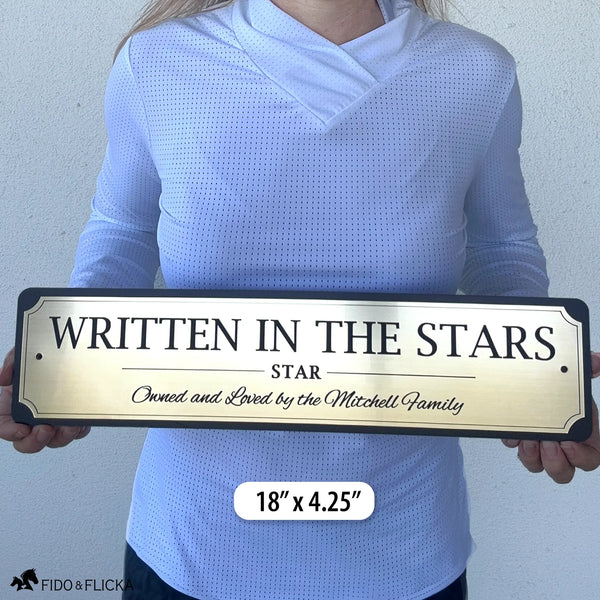 Person holding an 18-inch personalized horse stall sign to demonstrate the size of the premium engraved acrylic plaque.