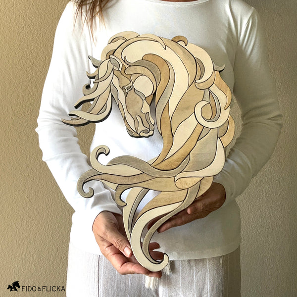 Woman holding Noble Drift layered wood horse sculpture by Fido & Flicka, showing size and handcrafted flowing design.