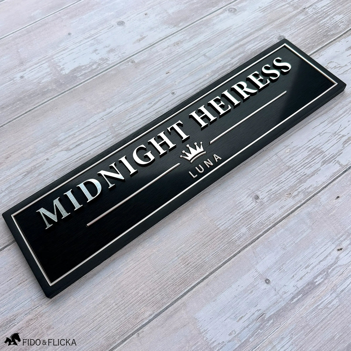 Black personalized horse stall sign with raised metallic lettering, Rosé Champagne accents, crown emblem, and the horse name Midnight Heiress.