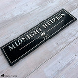 Black personalized horse stall sign with raised metallic lettering, Rosé Champagne accents, crown emblem, and the horse name Midnight Heiress.