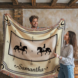 Two people holding a decorative blanket with dressage horse designs and the name 'Samantha'.