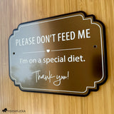 Brushed bronze horse stall sign with white engraving reading “Please Don’t Feed Me, I’m on a special diet” with a black layered backing.