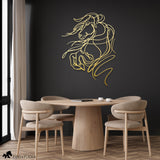 Gold metal wall art of a rearing horse with flowing lines, enhancing a modern dining room with a black accent wall and natural wood tones.