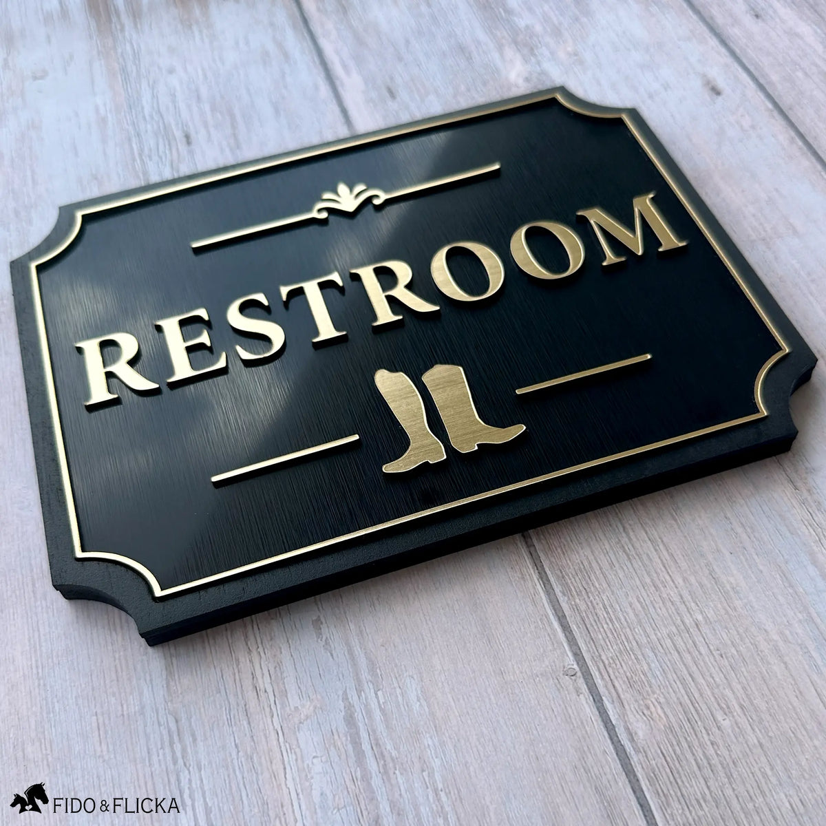 Restroom Sign with Riding Boots Icon
A tasteful equestrian restroom sign featuring a pair of riding boots. The raised gold details and classic silhouette make it a beautiful addition to a barn, stable, lounge, or event space.