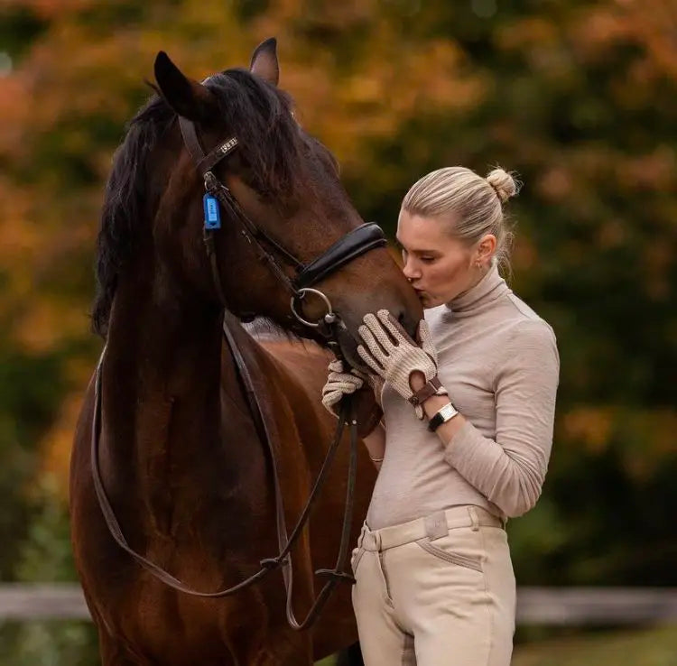 horse rider kissing her horse