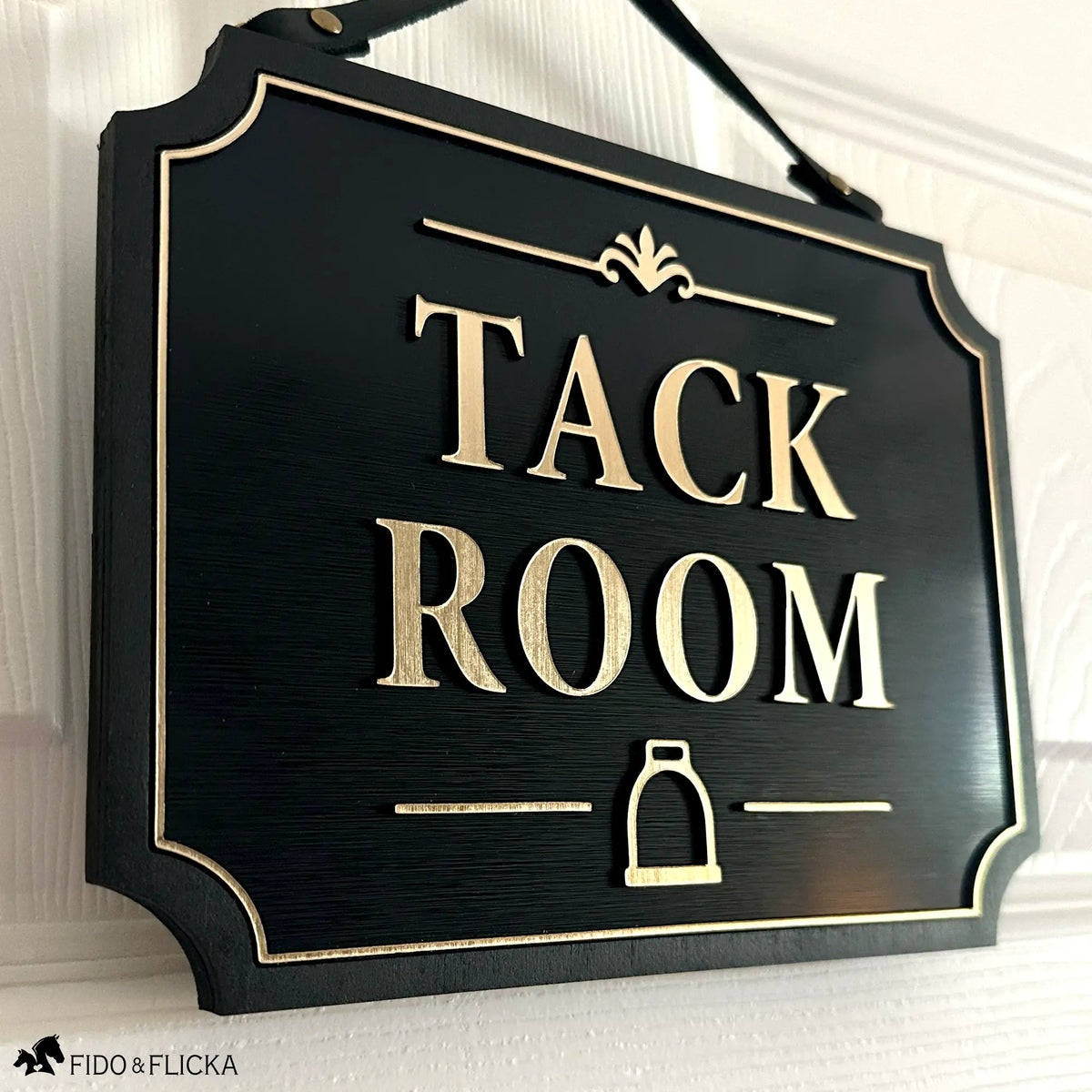 Tack Room Sign with Stirrup Icon
A classic finishing touch for the heart of your barn. This personalized Tack Room sign features raised gold lettering, a stirrup icon, and a genuine leather hanging strap for a warm, elevated equestrian look.