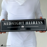 Person holding a 15.5-inch personalized horse stall sign to show the scale and size of the finished black and metallic name plate.