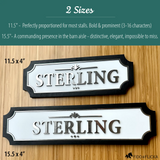 Personalized brushed-silver horse stall name sign on white with a black wood frame, shown in two sizes — 11.5″ × 4″ Standard and 15.5″ × 4″ Extended — both reading 