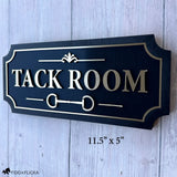 Custom Tack Room barn sign with raised brushed gold lettering, equestrian bit detail, decorative border, and black wood backing.