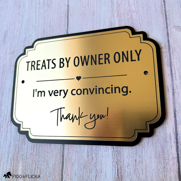 Brushed gold horse stall notice with black engraving reading “Treats By Owner Only, I’m very convincing” on a black acrylic backing.