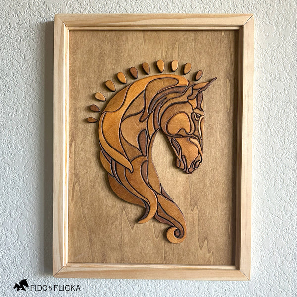 Frontal view of a handcrafted wood horse head wall art featuring layered, stained wooden pieces forming a Baroque-style design. The artwork is framed in natural wood and displayed against a lightly textured wall, highlighting the detailed contours and warm tones of the sculpture.