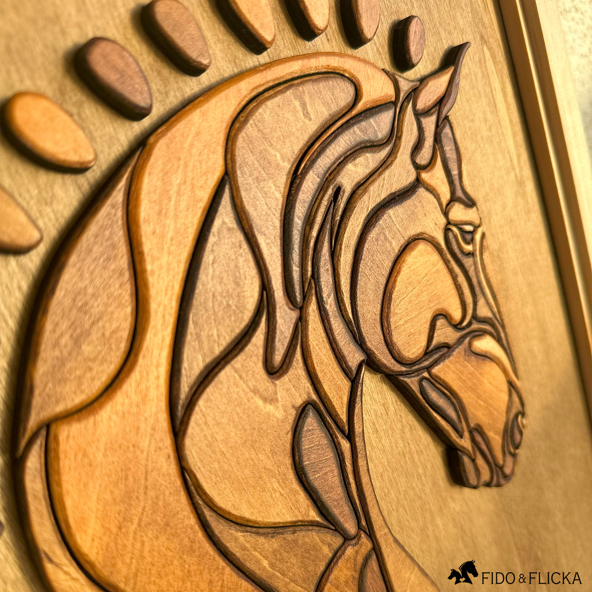 Close-up angled view of a handcrafted layered wood horse head wall art, showcasing detailed carving, smooth contours, and varied wood stains that enhance the dimensional texture. The horse’s mane and features are intricately formed, highlighting the craftsmanship against a warm wooden background.