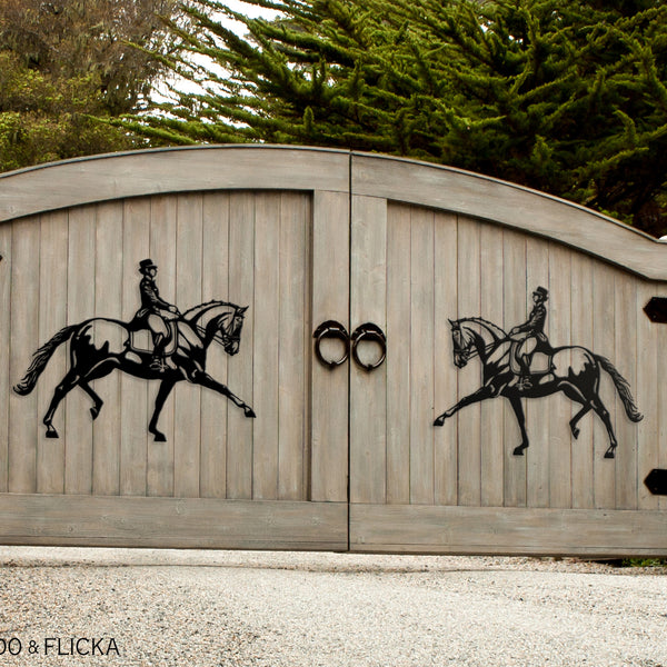 Metal dressage horses on wooden driveway gate